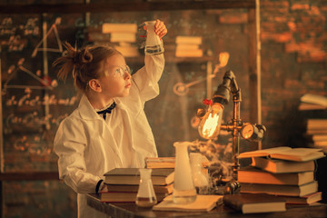 girl looking at liquid in test tube at lab