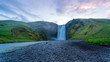 road in mountains and SKÓGAFOSS waterfalls sunrise in Iceland 