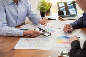 Teamwork graphic designers creative drawing website ux app development and application for mobile phone in the office.