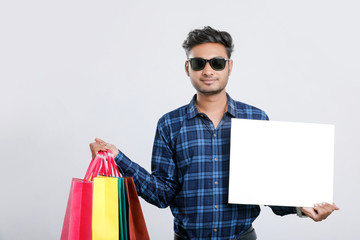 Wall Mural - young indian man with shopping bags, Indian festival