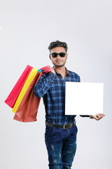 Wall Mural - young indian man with shopping bags, Indian festival