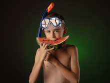 Boy In A Diving Mask And Eating Watermelon
