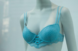 Fototapeta Sypialnia - Closeup of blue bra on mannequin in a fashion store for women showroom
