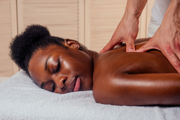 afro american female getting neck massage.