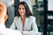 © bnenin - Portrait of a young smiling businesswoman in formal wear on a business meeting.
