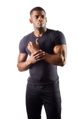 serious handsome male in stylish black t shirt, keeps hands, looks aside, thinks about something, poses over white wall. close up portrait. isolated white background. beauty, fashion, wellness