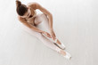 © Prostock-studio - Ballet Dancer Sitting On Floor In Studio, Overhead View