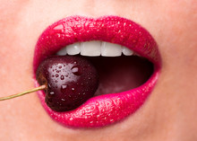 Red Lipstick On Lips And A Cherry With Water Droplets. The Girl Is Eating Cherry.