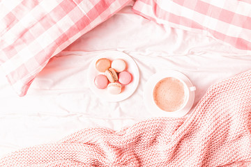 Wall Mural - Bed with pink knitted plaid, coffee and macaroons.