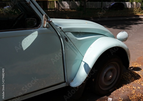 Fotografía Hellblaue französische Oldtimer Limousine steht am Straßenrand.