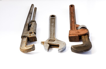 Old adjustable pipe wrenches on a white background