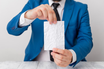 Wall Mural - Man holds empty paper with copy space in front of him. White space for advertising message.