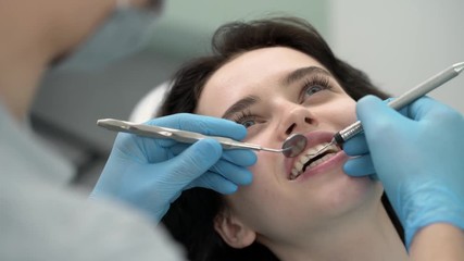 Wall Mural - Pretty woman's teeth treatment in dental clinic