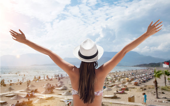 woman arms raised and looking beaches of turkey