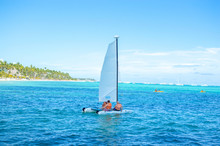 People Swim On A Yacht Among Palm Trees In The Resort Of Punta Cana.