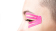 © Alex Photo - Anti-aging kinesiology tape on female eyelid, close-up.