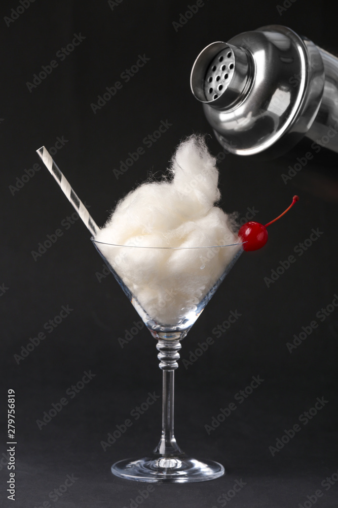 Preparing of tasty cotton candy cocktail on dark background