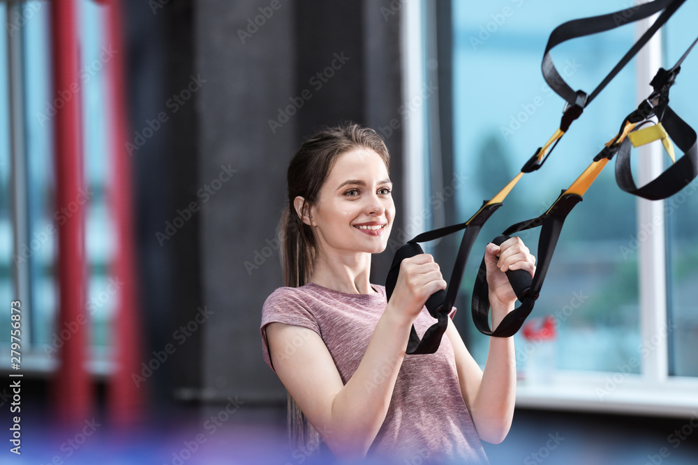 Sporty young woman training in gym