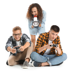 Wall Mural - Teenage boys playing video game and African-American girl with megaphone on white background