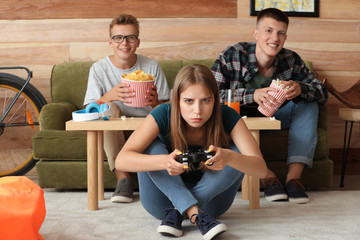 Wall Mural - Teenagers playing video game at home