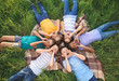 © Pixel-Shot - Group of children lying on plaid in park
