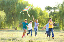 Children Flying Kite On Summer Day
