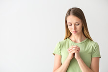 Religious Young Woman Praying On White Background