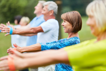 senior group with stretch band in pilates class