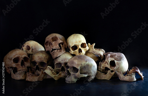 Pile Of Skulls Put On Dark Floor And Black Background Dim Light