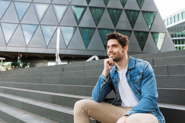 Wall Mural - Handsome young man dressed casually spending time outdoors