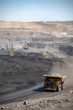 © Christopher - Big yellow mining truck hauling rock in dusty coal mine