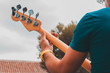 © Ana - Man playing an electric guitar at a concert