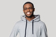 © fizkes - Smiling black male in hoodie posing for picture