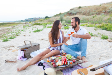 Wall Mural - Picnic on the beach at sunset in the style of boho, food and drink conception