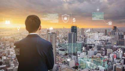 Futuristic augmented reality online data and cyberspace, Businessman looking at the city with futuristic online data hologram 