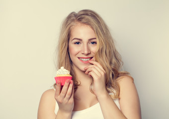 Smiling Cute Girl holding Cake in her hands. Woman with Beautifu