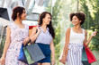 © Syda Productions - sale, consumerism and people concept - happy young women with shopping bags walking along city street