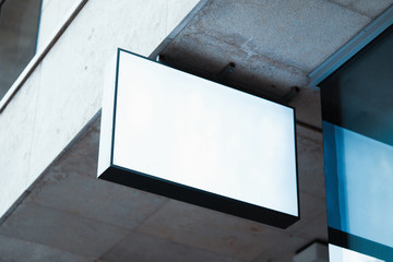 Wall Mural - Blank store signboard mockup. Empty shop signage template mounted on the wall. Street sign, 3d rendering.