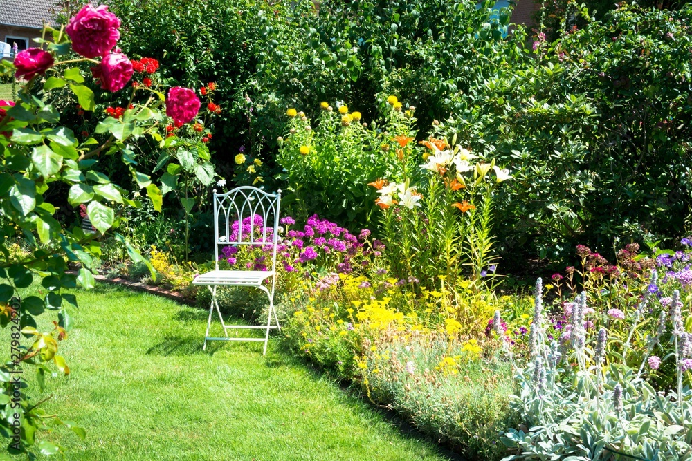 Beautiful garden with chair - obrazy, fototapety, plakaty 