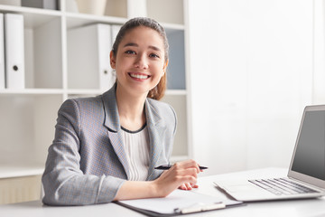 Cheerful office worker with clipboard