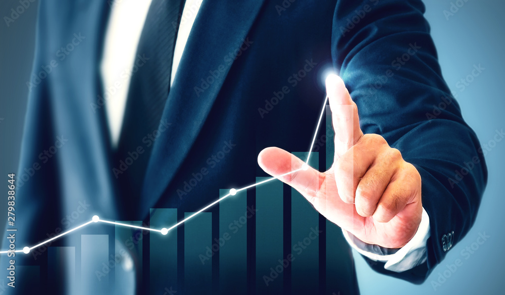 Businessman showing business growth on a chart, hands touch the graph ...