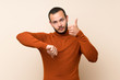 © luismolinero - Colombian man with turtleneck sweater making good-bad sign. Undecided between yes or not