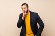 © luismolinero - Colombian man over isolated background doing silence gesture