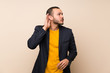 © luismolinero - Colombian man over isolated background listening something