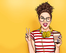 Winking Woman In Glasses With Head Phones Makes Peace Gesture  Pop Art Girl Holding Coffee Cup.