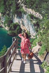 Wall Mural - woman walking by hiking trail around braies lake in italy dolomites mountains. activity leisure lifestyle