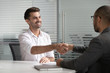 © fizkes - Happy male job applicant manager get hired handshaking hr client