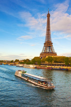 France, Paris, Eiffel Tower And Tourist Boat On River Seine