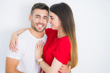 Young beautiful couple in love hugging over white isolated background