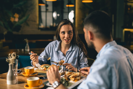 A happy young couple having dinner at a fancy restaurant